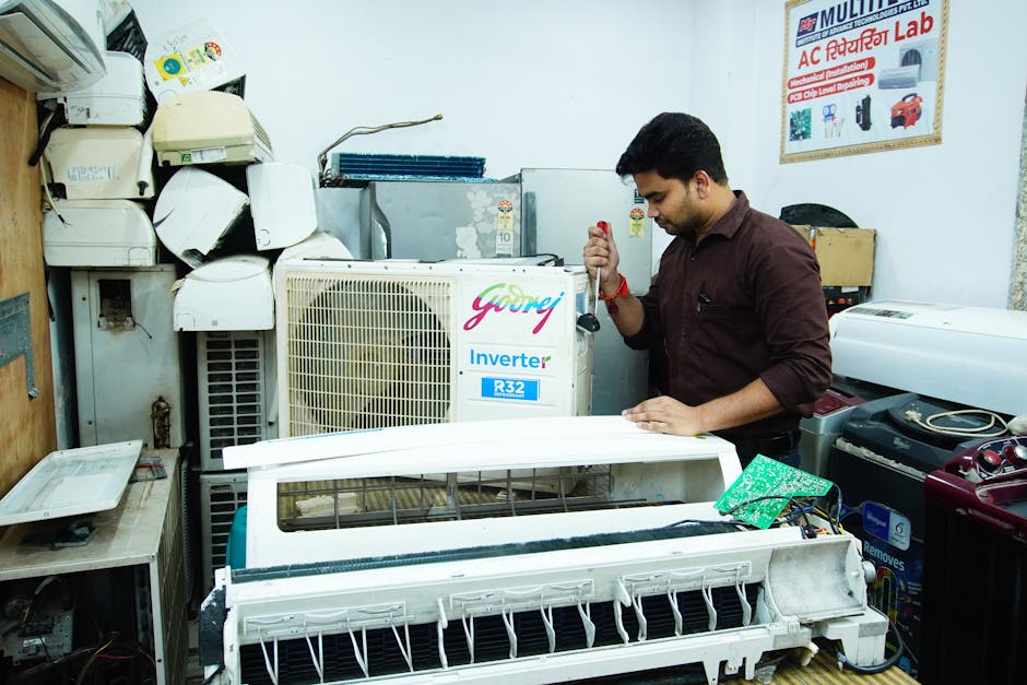 HVAC Blog 5 AC tune-up technician inspecting outdoor condenser unit in New Jersey spring - how often should you schedule an ac tune up